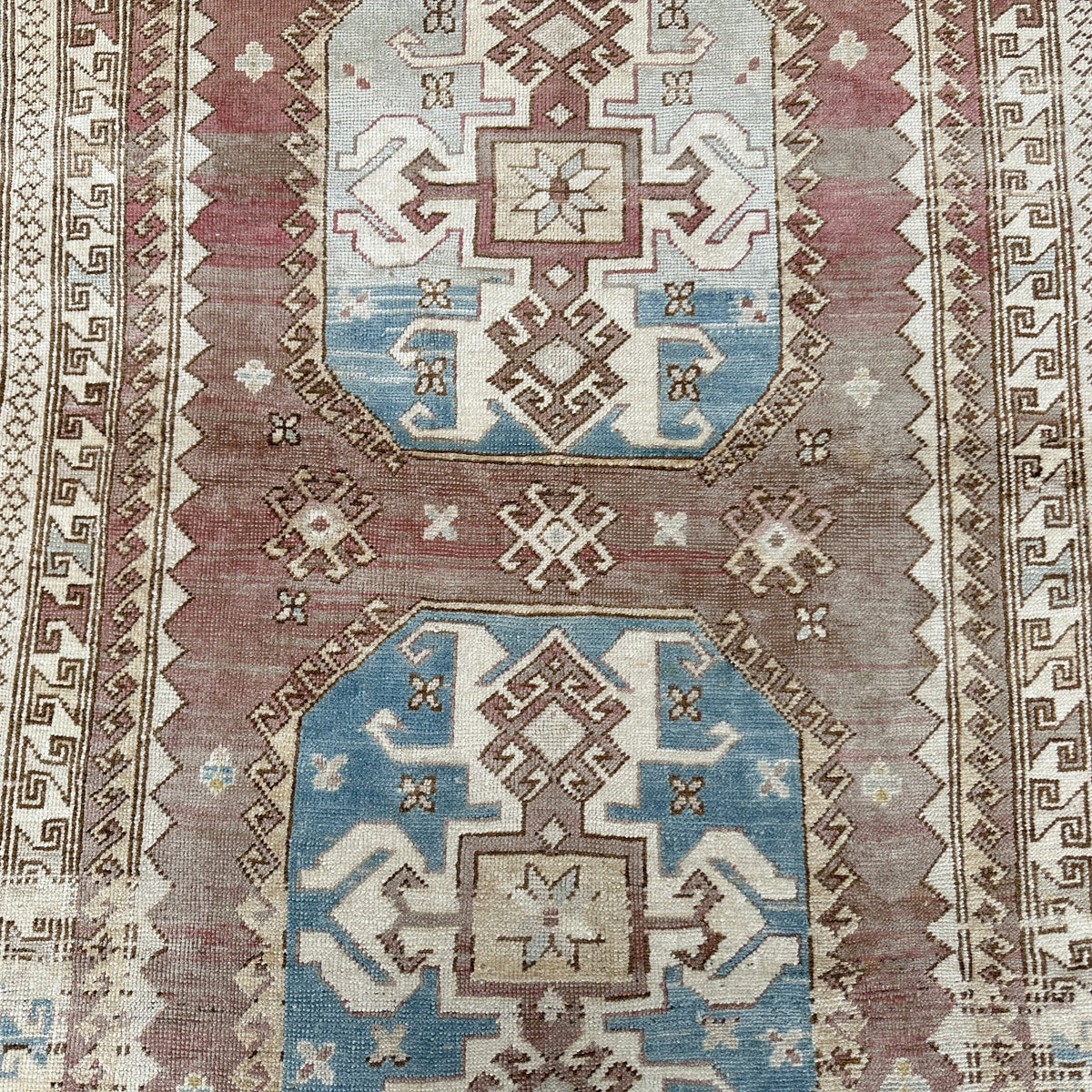 1970s pale red vintage Turkish wool rug with traditional design, hand-knotted weave and low pile.