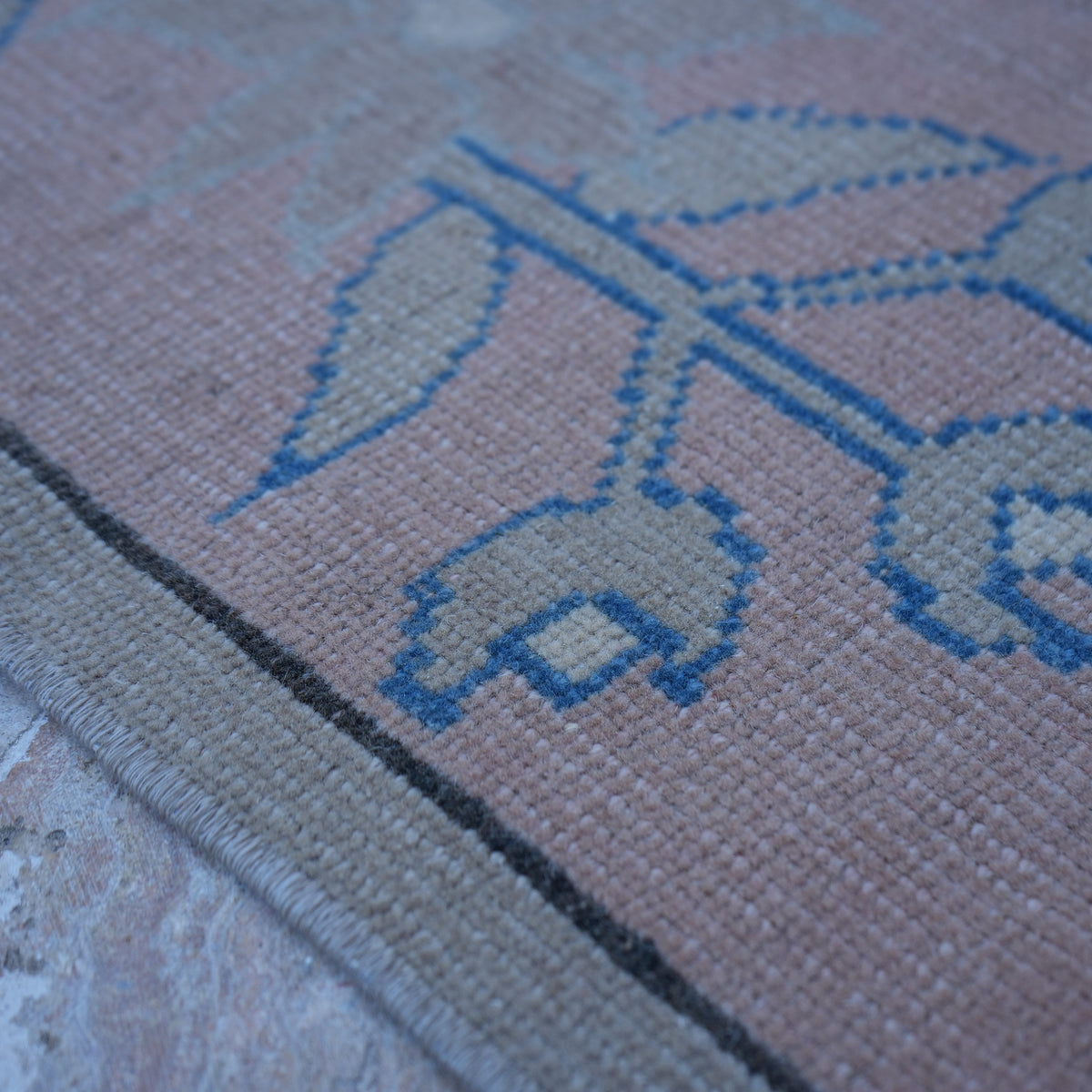 Pink 4' x 6' vintage Turkish wool rug in wool, shown on the floor.