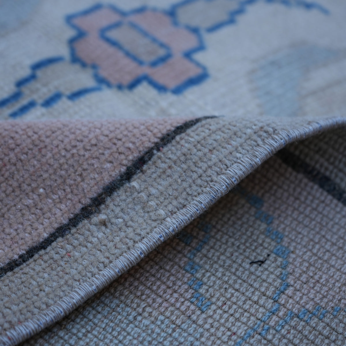 Additional view of the pink vintage Turkish wool rug, hand-knotted in wool.