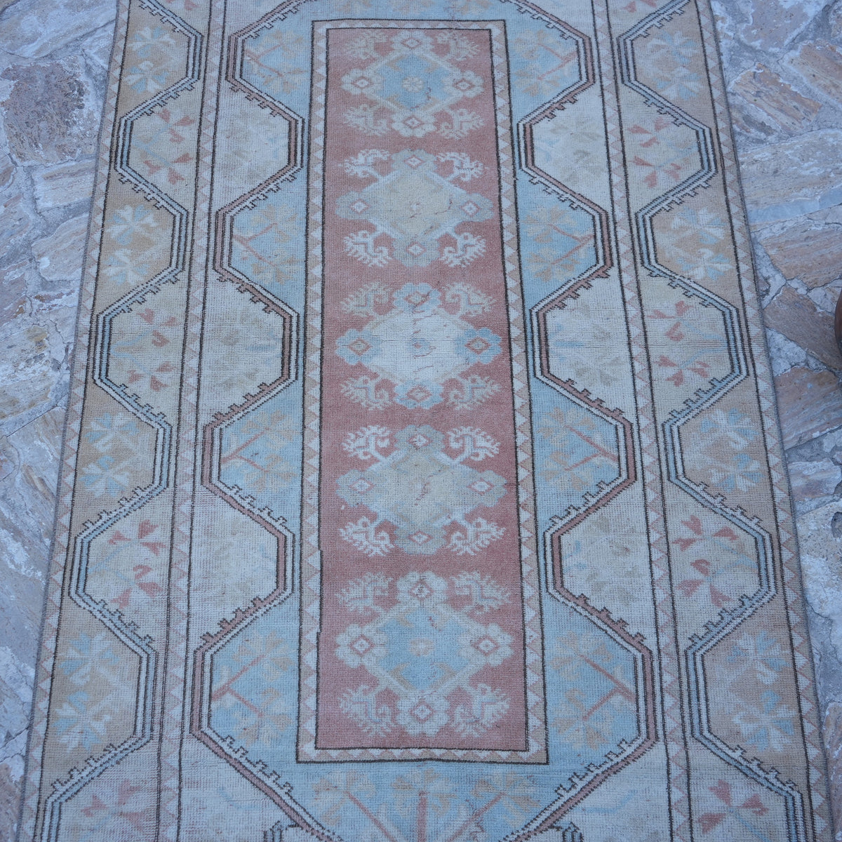 Close-up of the beige vintage Turkish wool rug showing traditional details, hand-knotted weave, wool and low pile.