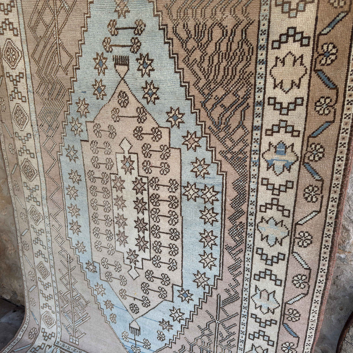 Blue 4' x 7' vintage Turkish wool rug in wool and cotton, shown on the floor.