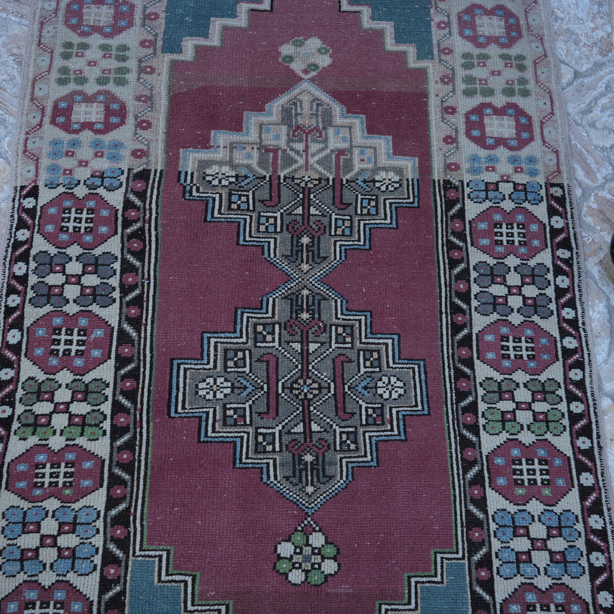 Close-up of the pale purple vintage Turkish wool rug showing traditional details, hand-knotted weave, wool and low pile.