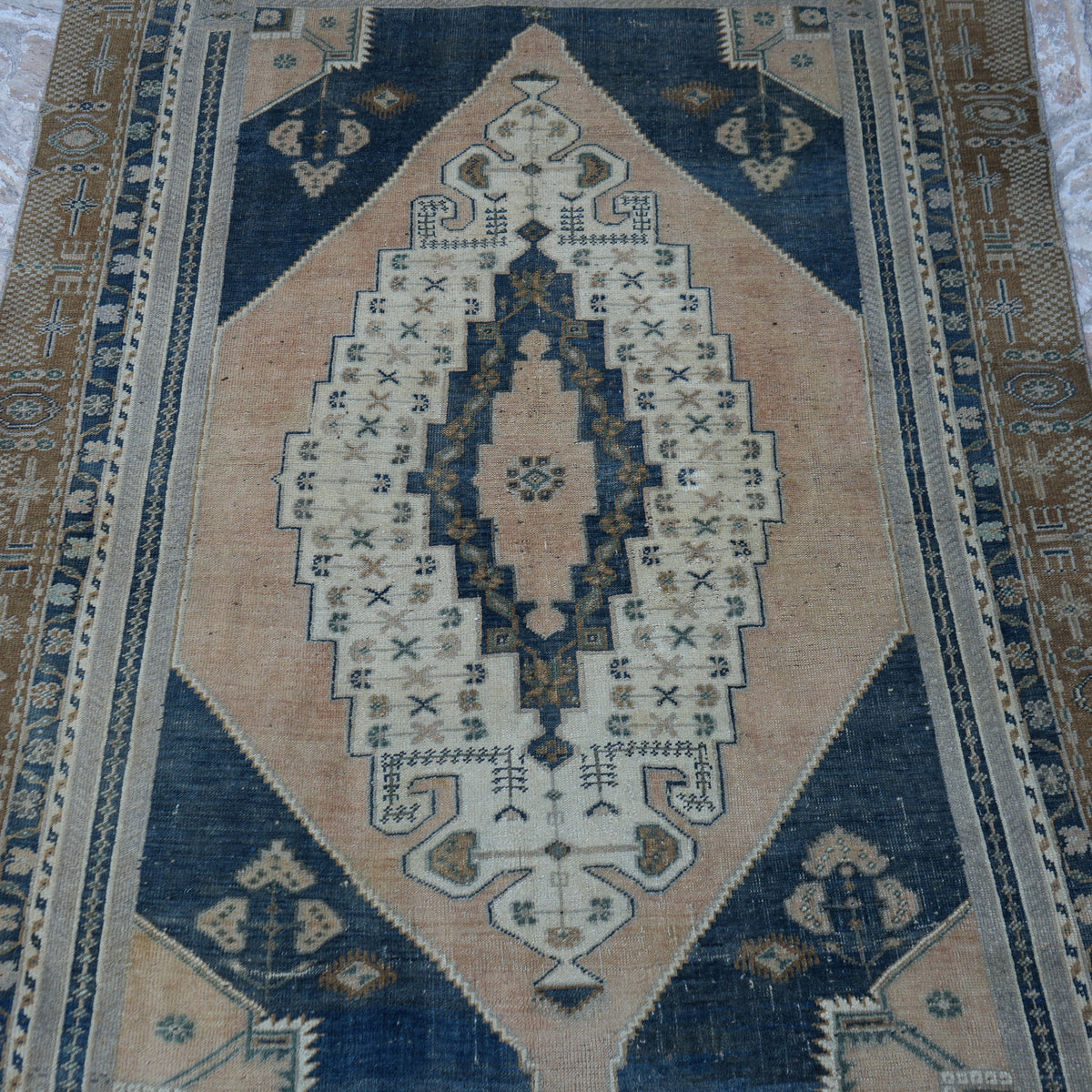 Close-up of the blue vintage Turkish wool rug showing neutral details, hand-knotted weave, wool and low pile.