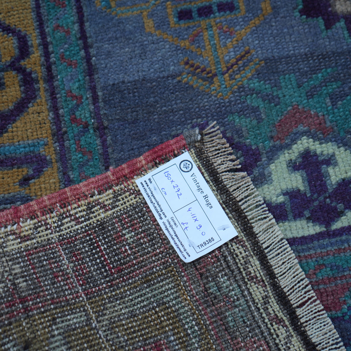 Purple 5' x 9' vintage Turkish wool rug from the 1970s with traditional design.