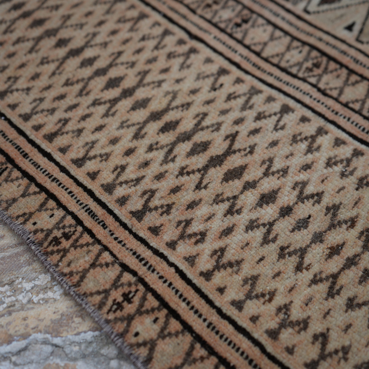 Pale Orange 7' x 11' vintage Turkish wool rug in wool, shown on the floor.