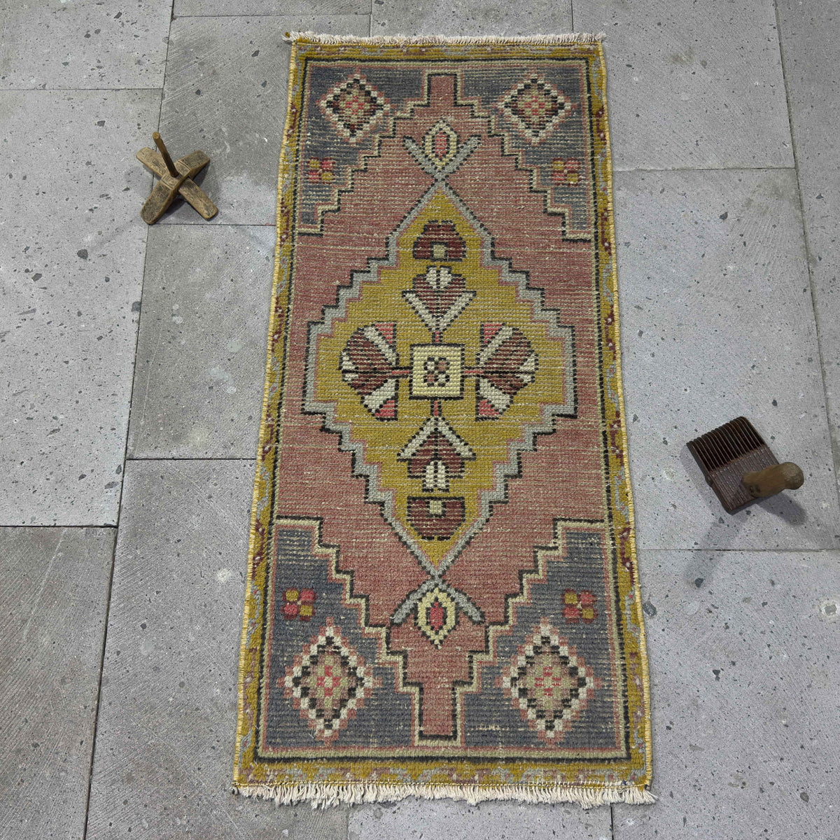 Yellow 2' x 3' Turkish wool traditonal rug in wool and cotton, shown on the floor.