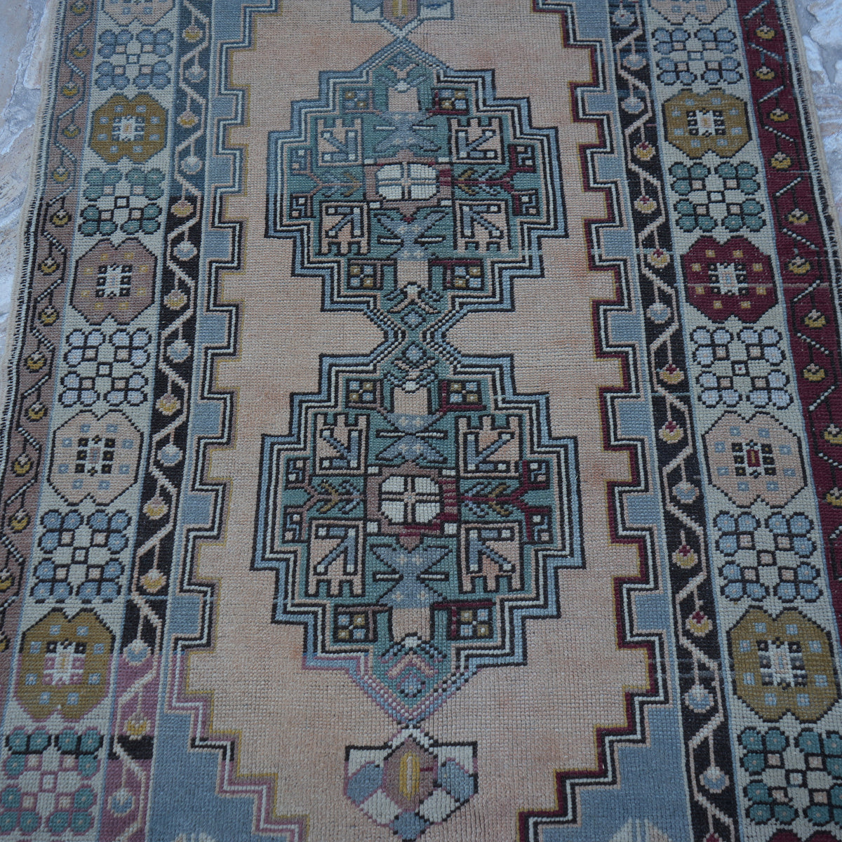 Close-up of the blue Turkish wool vintage rug showing geometric details, hand-knotted weave, wool and low pile.