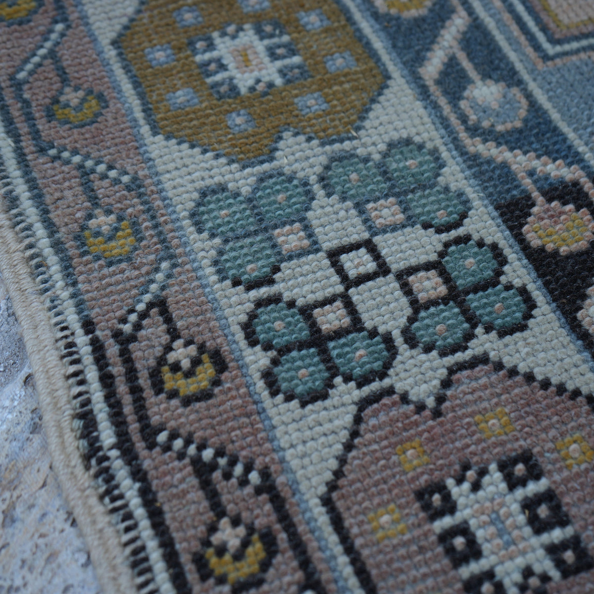 Blue 4' x 7' Turkish wool vintage rug in wool, shown on the floor.