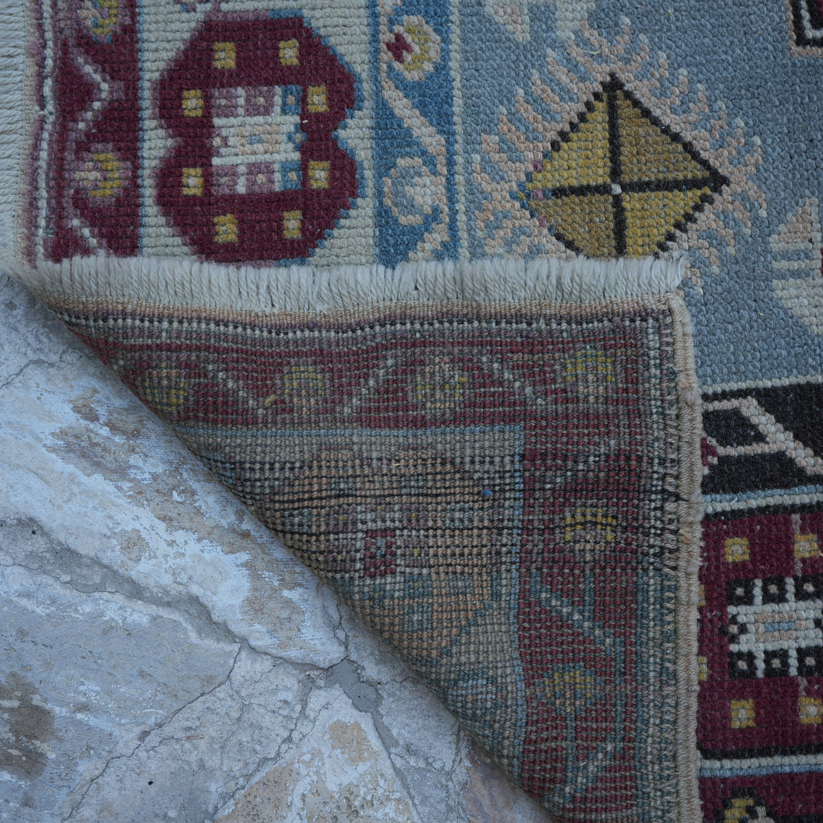 1970s blue Turkish wool vintage rug with geometric design, hand-knotted weave and low pile.