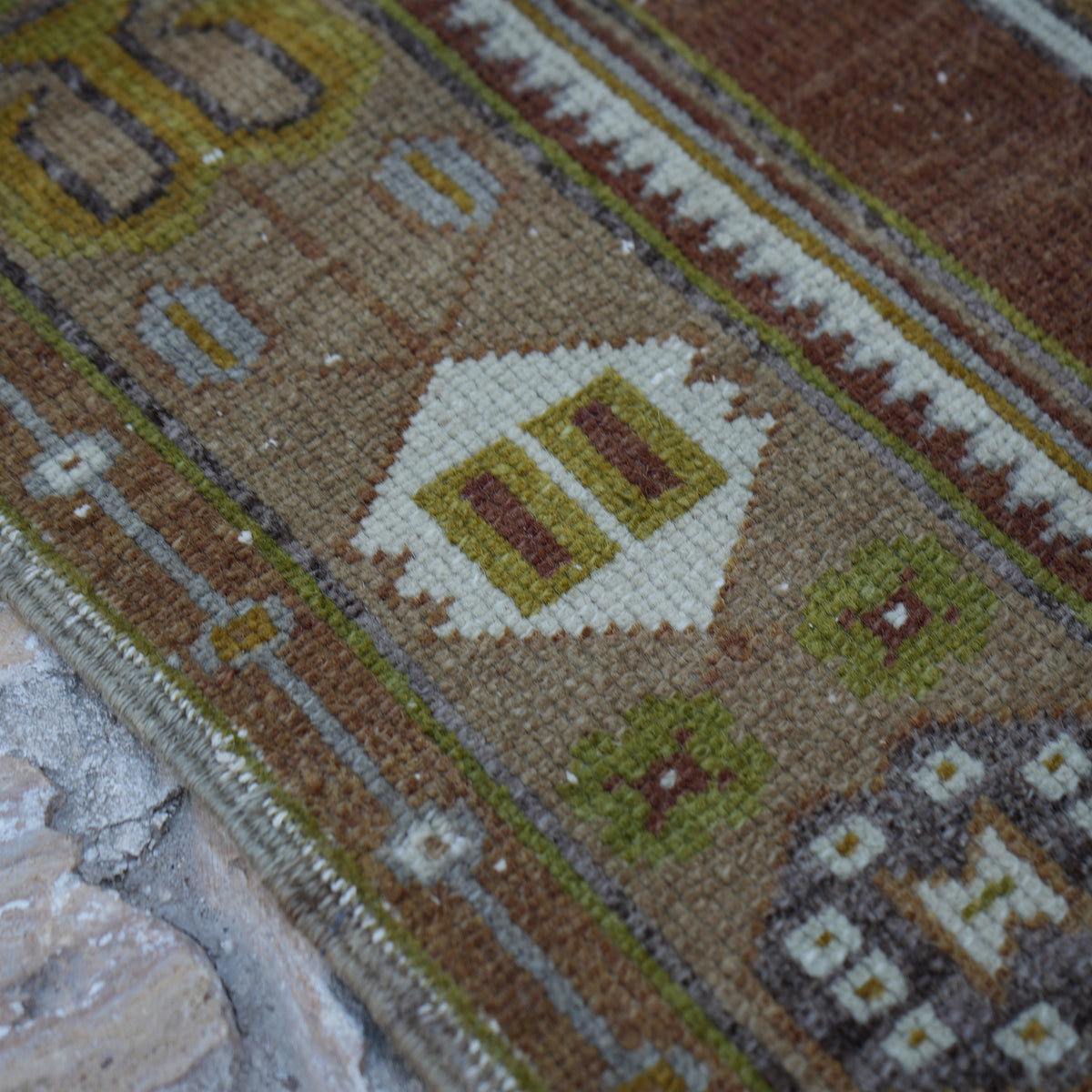 Brown 4' x 7' Turkish wool vintage rug in wool, shown on the floor.