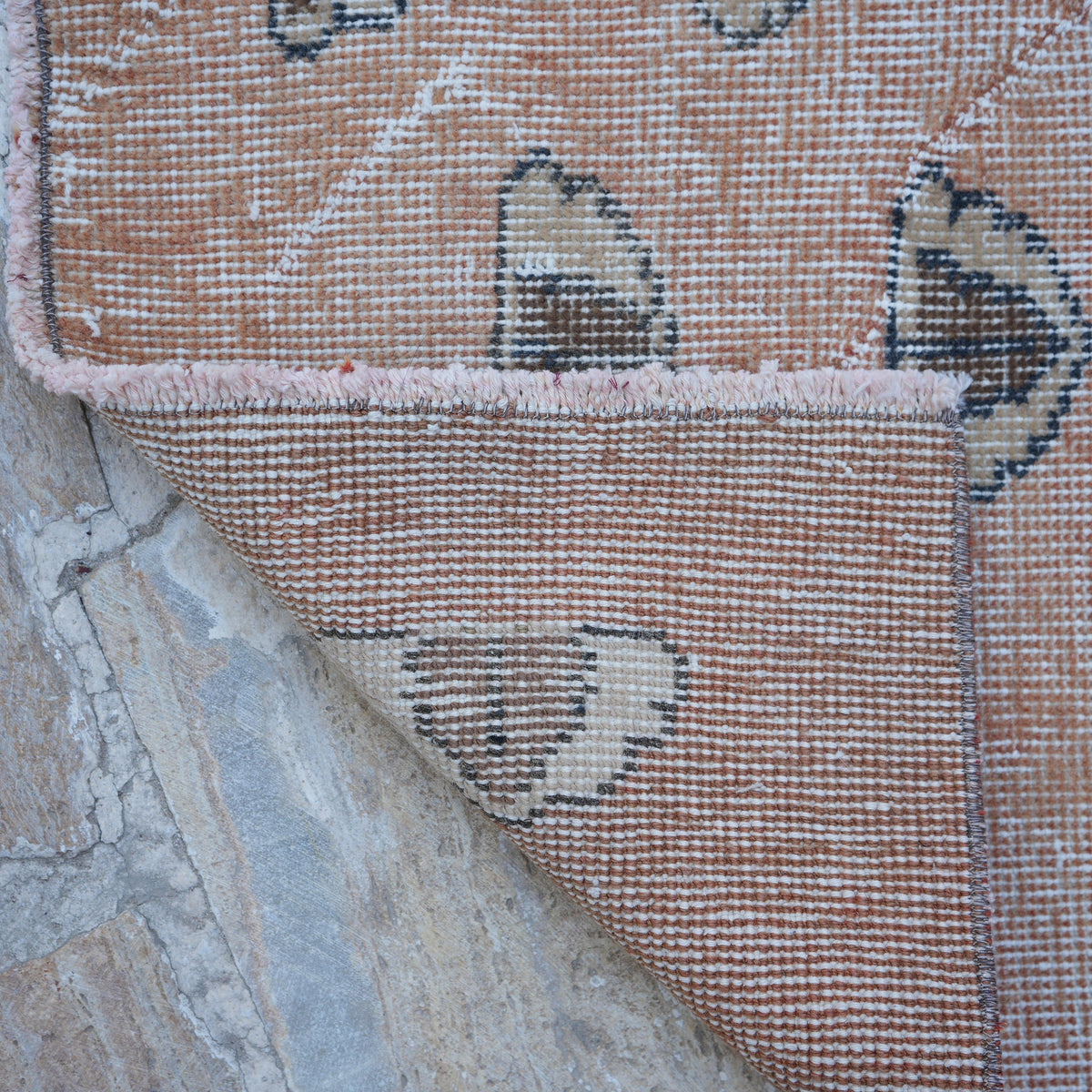 1970s pale orange Turkish art decor rug with traditional design, hand-knotted weave and low pile.