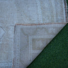 1970s beige Turkish authentic vintage rug with neutral design, hand-knotted weave and low pile.