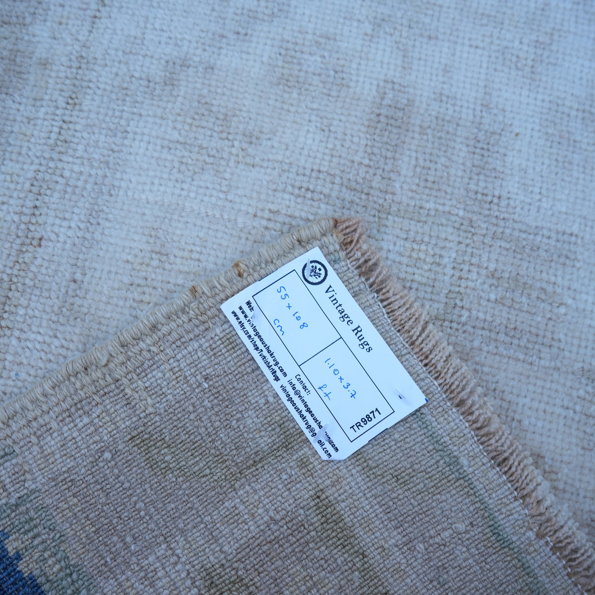 Beige 2' x 4' Turkish authentic vintage rug from the 1970s with neutral design.