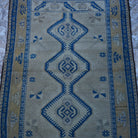 Close-up of the beige Turkish authentic vintage rug showing traditional details, hand-knotted weave, wool and low pile.