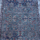 Close-up of the blue Turkish authentic vintage rug showing traditional details, hand-knotted weave, wool and cotton and low pile.