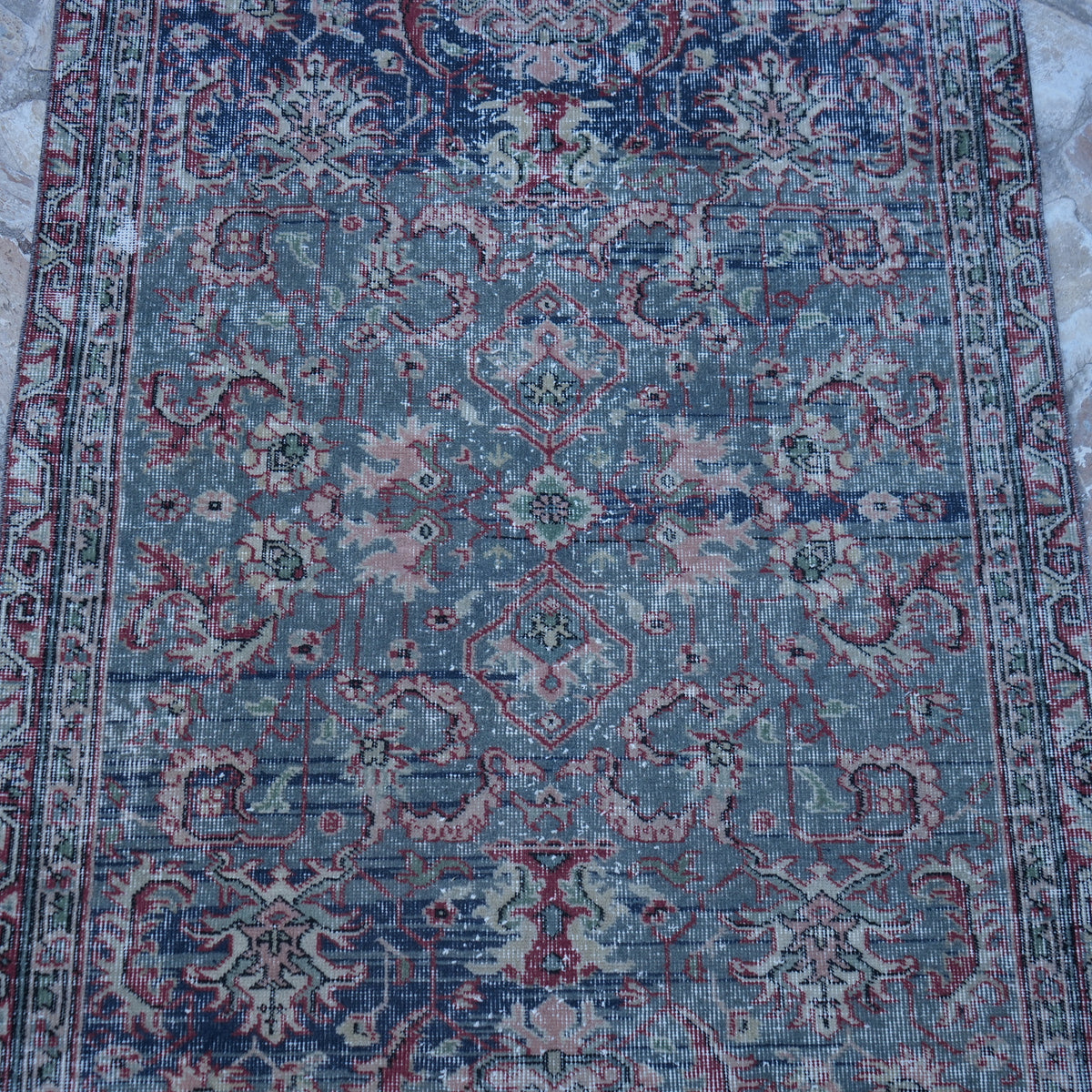 Close-up of the blue Turkish authentic vintage rug showing traditional details, hand-knotted weave, wool and cotton and low pile.