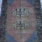 Close-up of the pale blue Turkish authentic vintage rug showing traditional details, hand-knotted weave, wool and low pile.