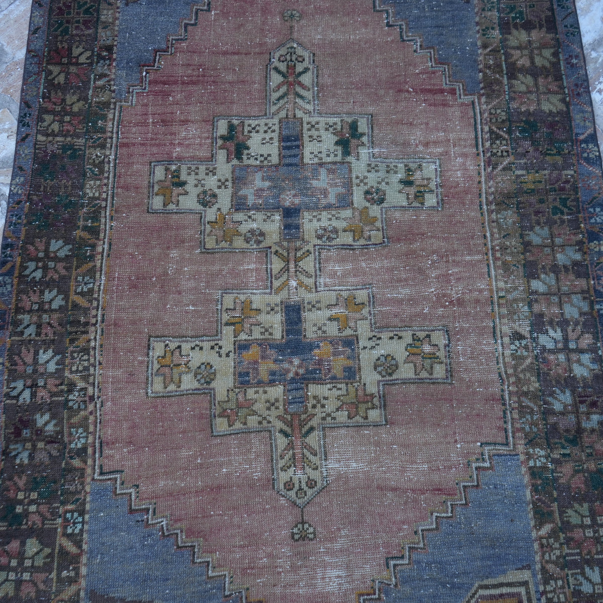 Close-up of the pale blue Turkish authentic vintage rug showing traditional details, hand-knotted weave, wool and low pile.