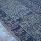 Pink 4' x 7' Turkish authentic vintage rug in wool, shown on the floor.