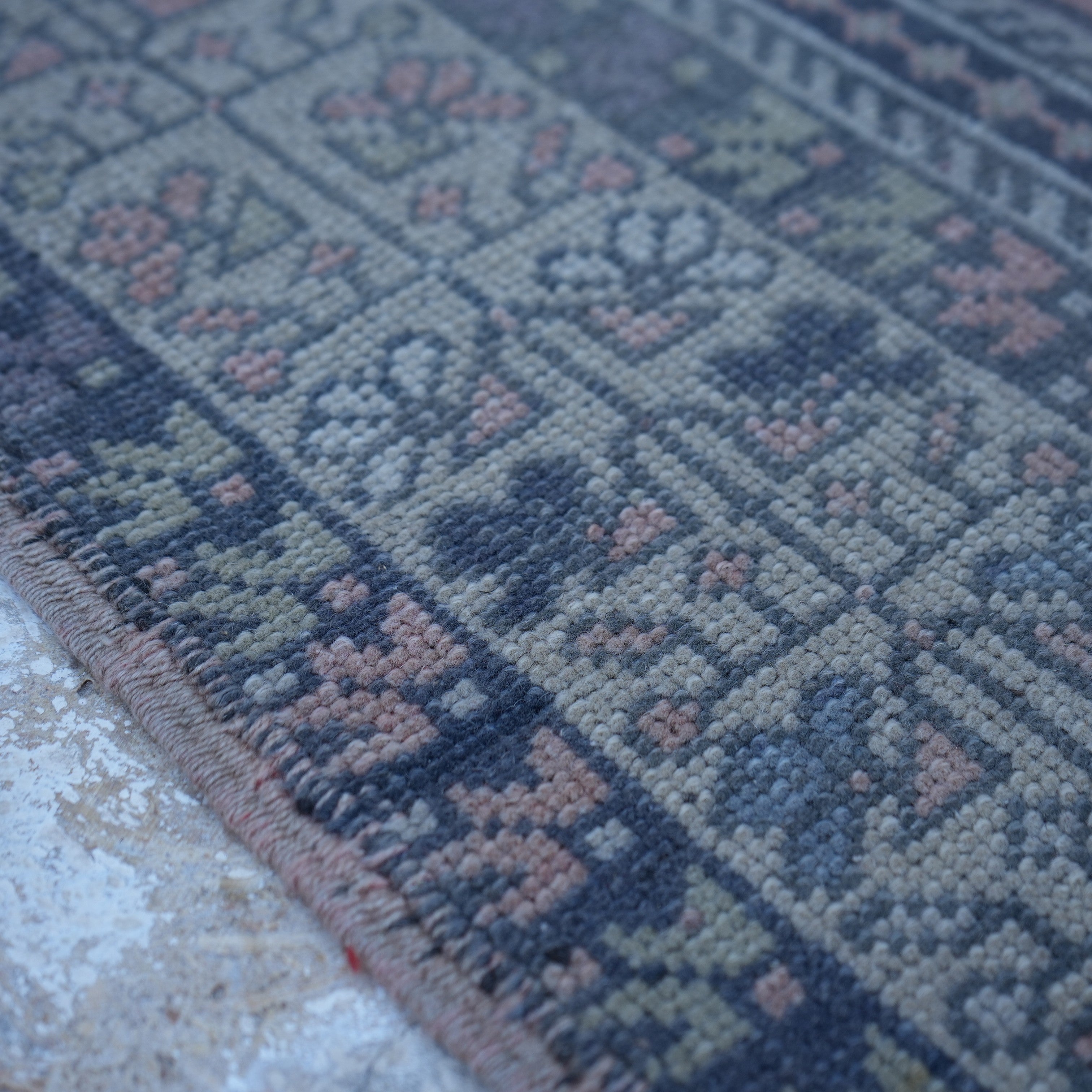 Pink 4' x 7' Turkish authentic vintage rug in wool, shown on the floor.