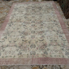 Beige 8' x 11' Turkish authentic vintage rug in wool and cotton, shown on the floor.