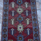 Close-up of the red Turkish authentic vintage rug, hand-knotted weave, wool and low pile.