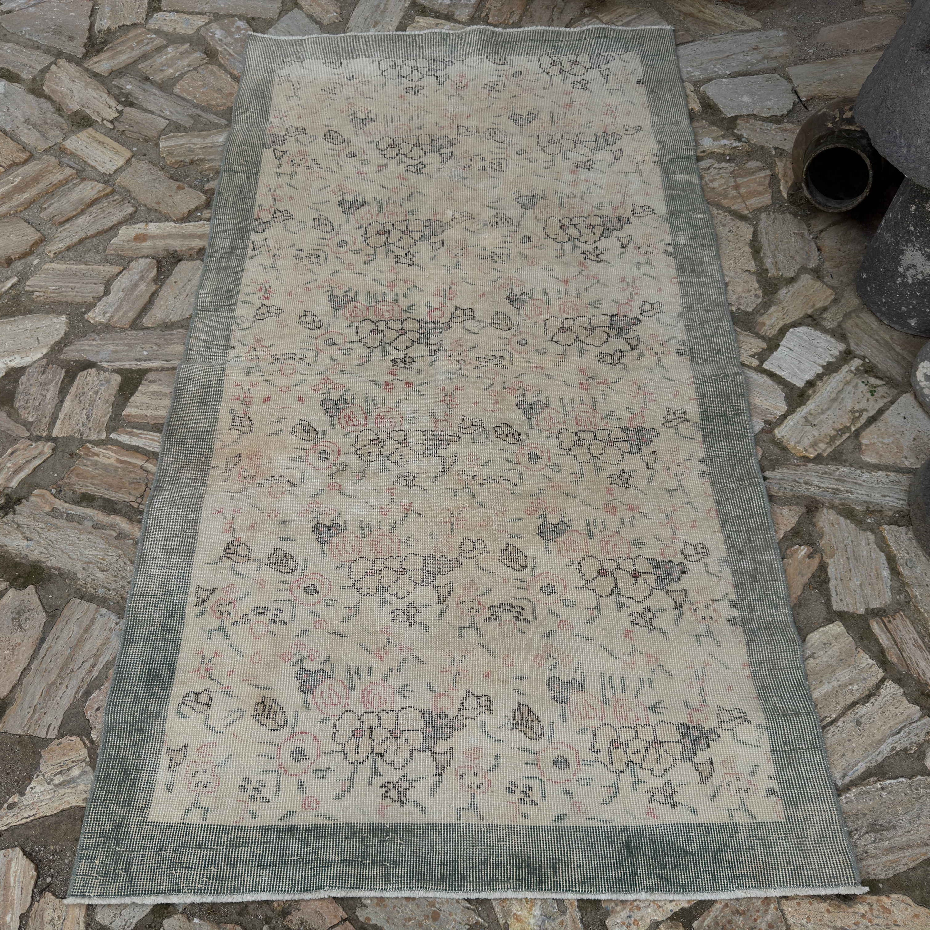Pale Green 4' x 7' Turkish distressed floral rug in wool and cotton, shown on the floor.
