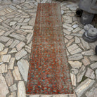Red 2' x 9' Turkish distressed floral runner rug in wool and cotton, shown on the floor.