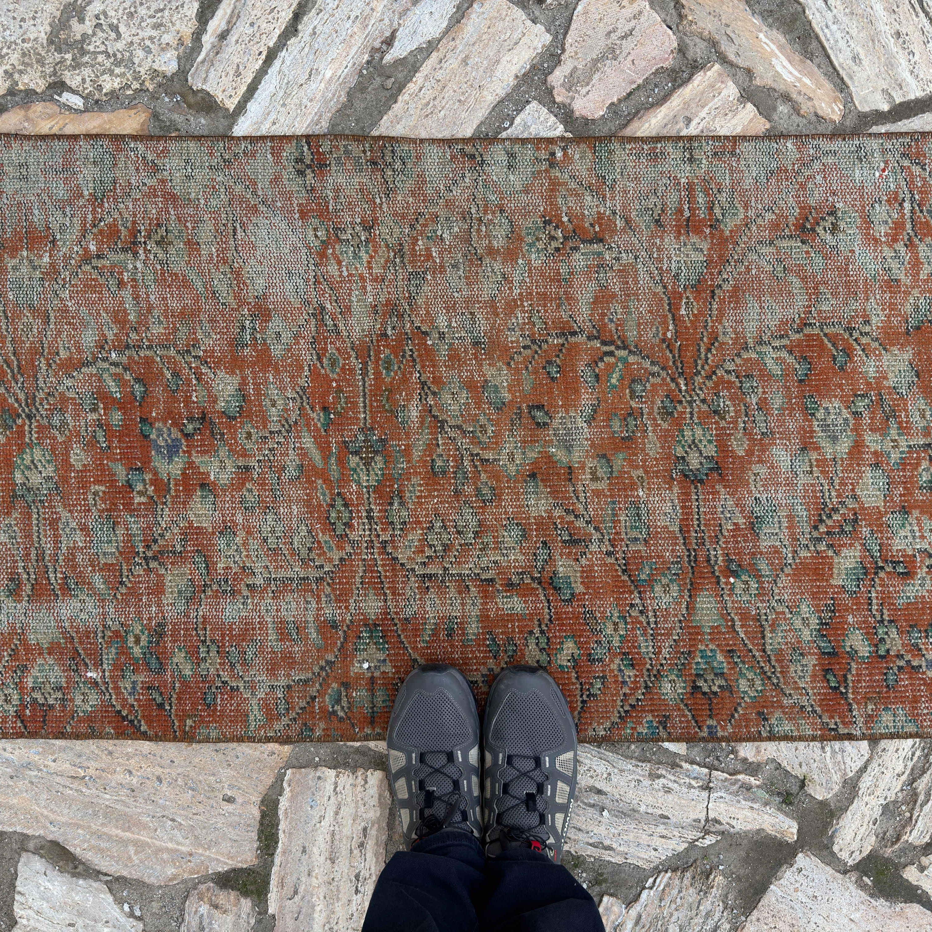 1970s red Turkish distressed floral runner rug with floral design, hand-knotted weave and low pile.
