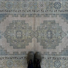 1970s beige Turkish distressed rug with traditional design, hand-knotted weave and low pile.