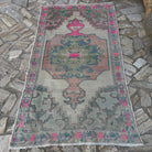Pink 4' x 7' Turkish distressed rug in wool and cotton, shown on the floor.