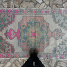 1970s pink Turkish distressed rug with traditional design, hand-knotted weave and low pile.