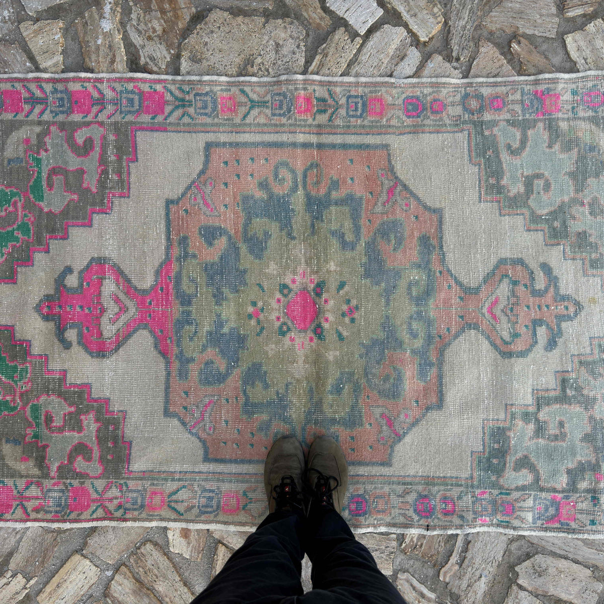 1970s pink Turkish distressed rug with traditional design, hand-knotted weave and low pile.