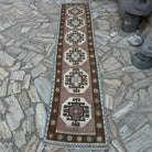 Brown 2' x 9' Turkish distressed runner rug in wool and cotton, shown on the floor.