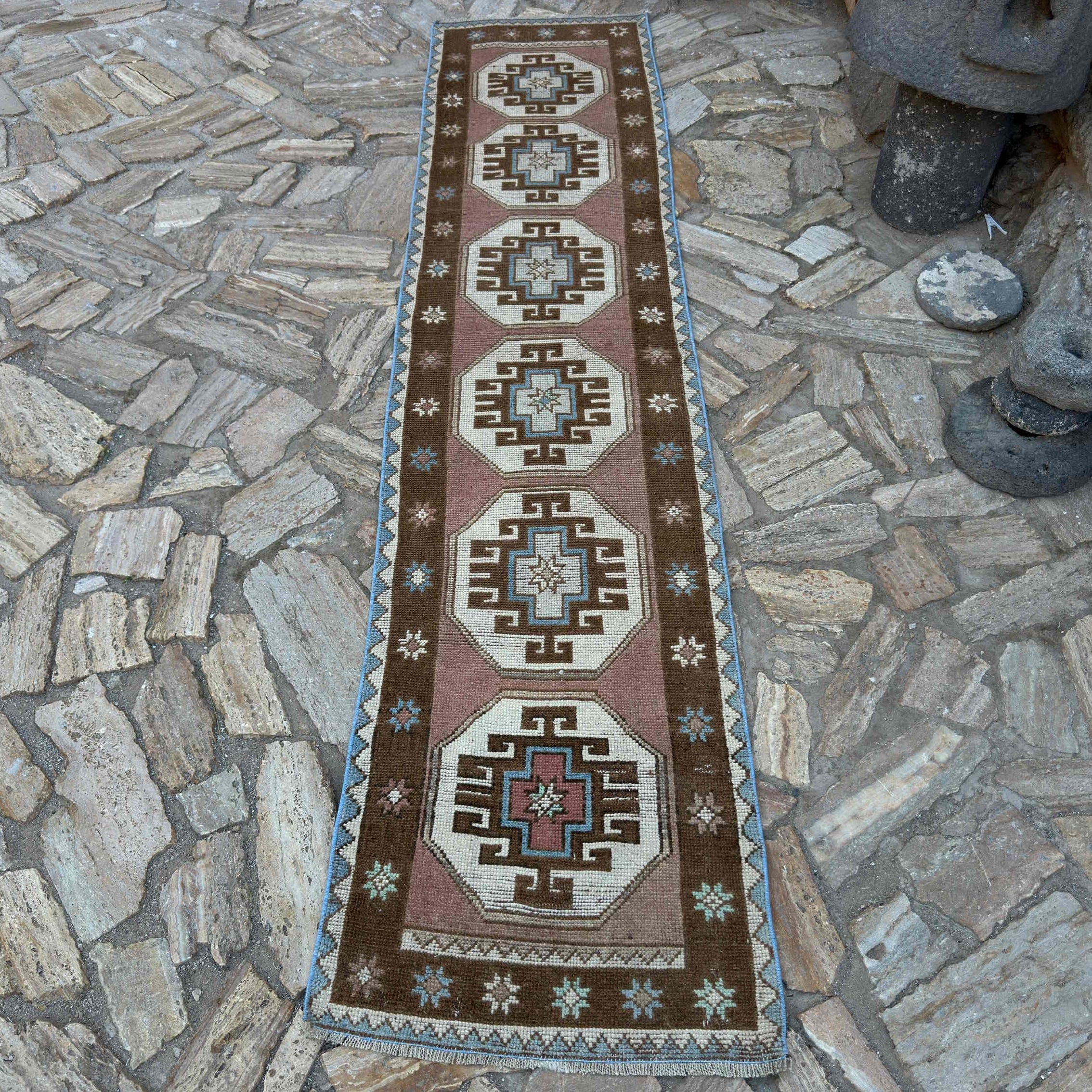 Brown 2' x 9' Turkish distressed runner rug in wool and cotton, shown on the floor.