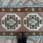 1970s brown Turkish distressed runner rug with oushak design, hand-knotted weave and low pile.
