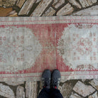 1970s pale red Turkish distressed runner rug with traditional design, hand-knotted weave and low pile.