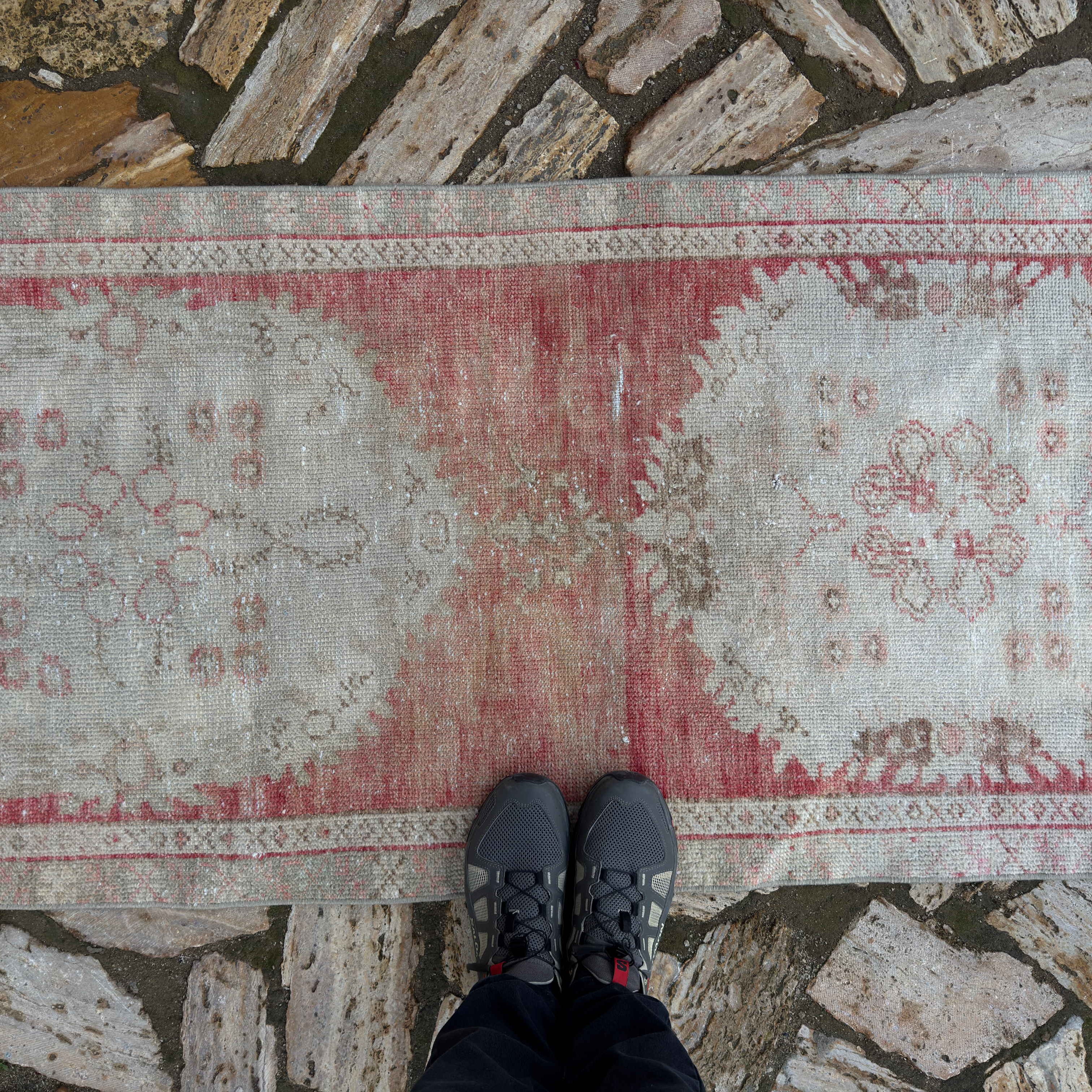 1970s pale red Turkish distressed runner rug with traditional design, hand-knotted weave and low pile.