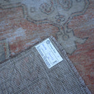 Red 3' x 5' distressed turkish rug from the 1970s with traditional design.
