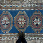1970s blue distressed turkish rug with medallion design, hand-knotted weave and low pile.