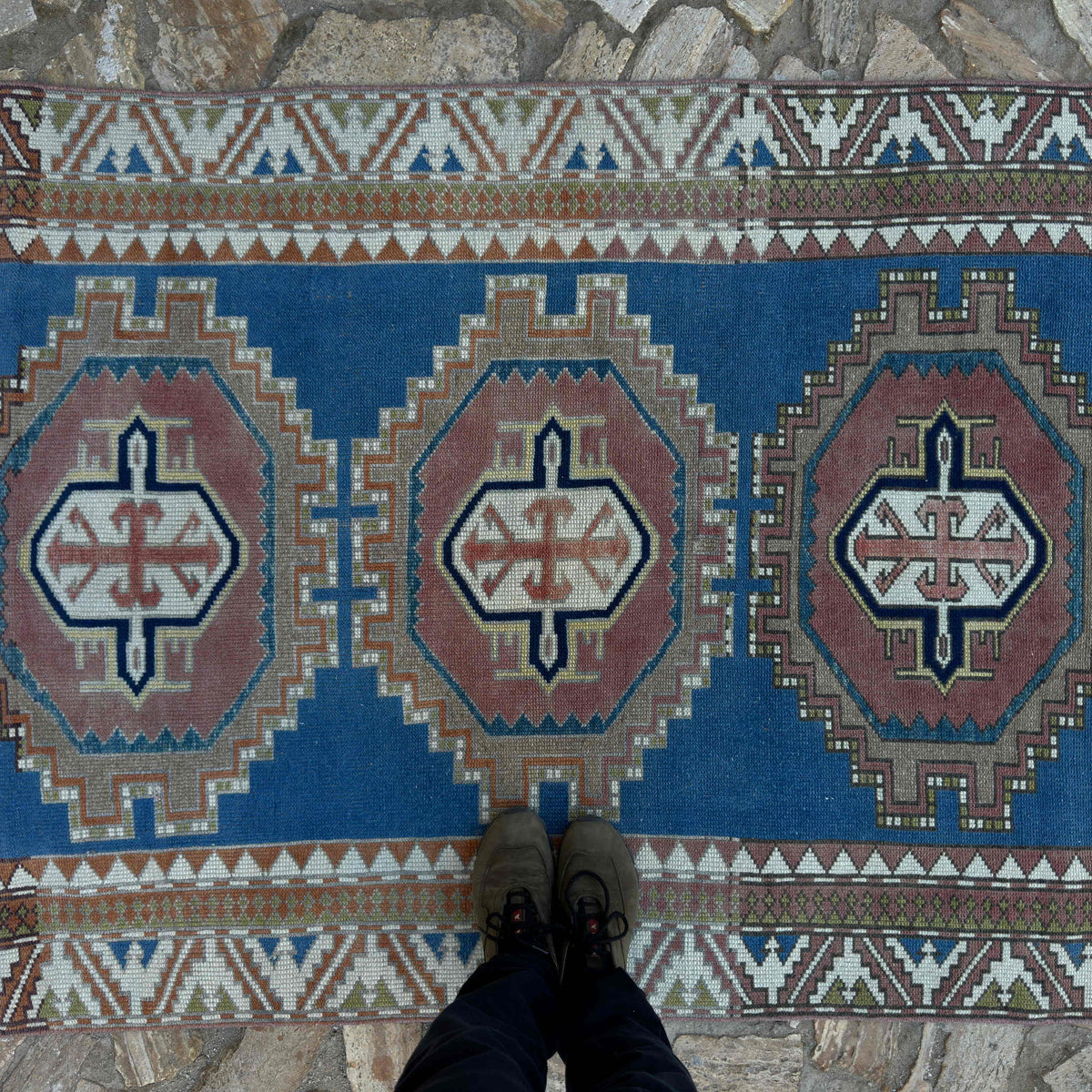 1970s blue distressed turkish rug with medallion design, hand-knotted weave and low pile.