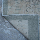 1970s beige Turkish distressed vintage rug with floral design, hand-knotted weave and low pile.