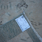 Beige 4' x 6' Turkish distressed vintage rug from the 1970s with floral design.