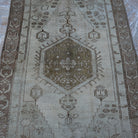 Close-up of the brown Turkish distressed vintage rug showing traditional details, hand-knotted weave, wool and low pile.