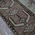 Brown 4' x 7' Turkish distressed vintage rug in wool, shown on the floor.