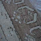 1970s brown Turkish distressed vintage rug with traditional design, hand-knotted weave and low pile.