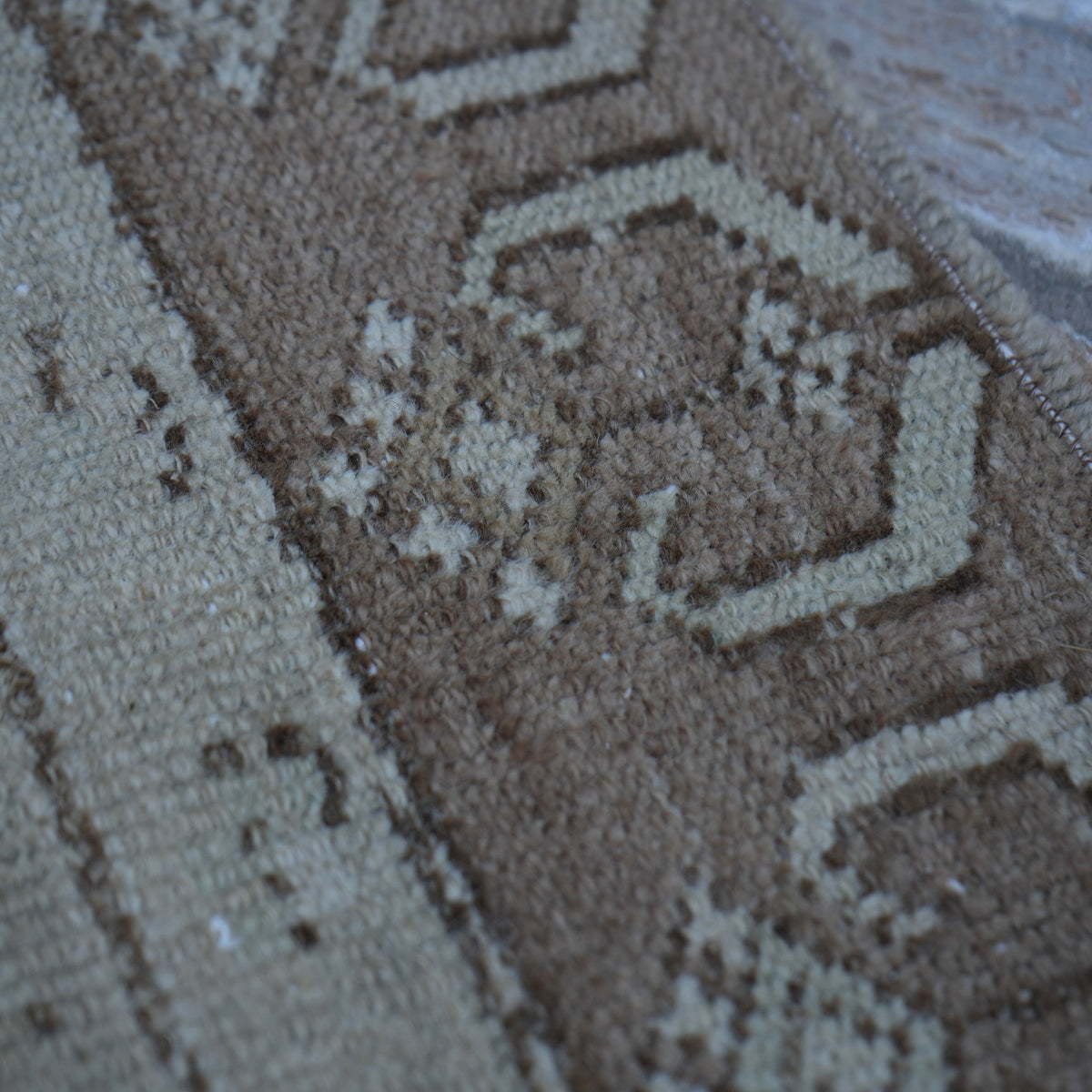 1970s brown Turkish distressed vintage rug with traditional design, hand-knotted weave and low pile.