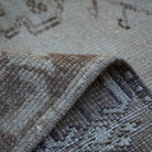 Brown 4' x 7' Turkish distressed vintage rug from the 1970s with traditional design.