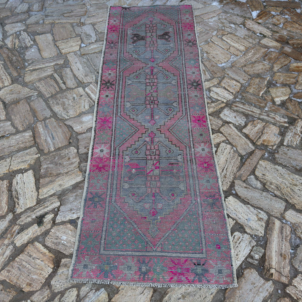 Pink 3' x 8' Turkish distressed vintage runner in wool and cotton, shown on the floor.