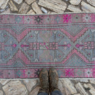 1970s pink Turkish distressed vintage runner with traditional design, hand-knotted weave and low pile.